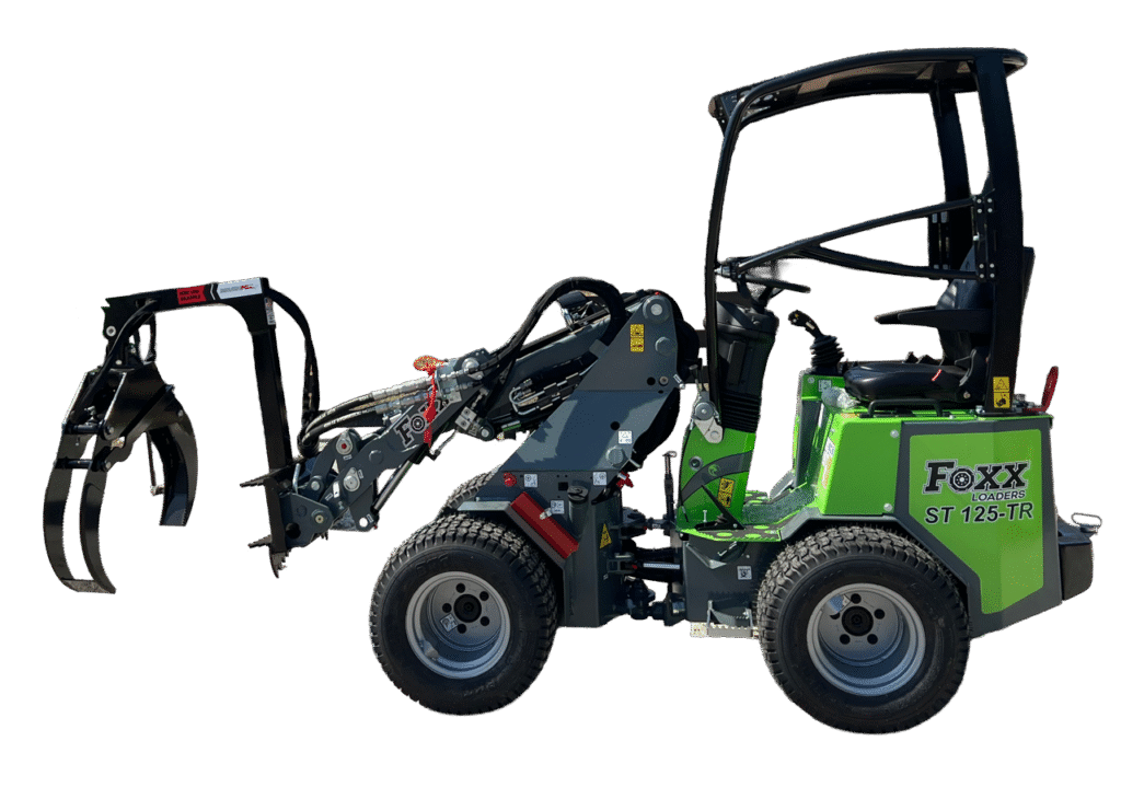 A Foxx Loaders ST125-TR compact wheel loader working on a yard