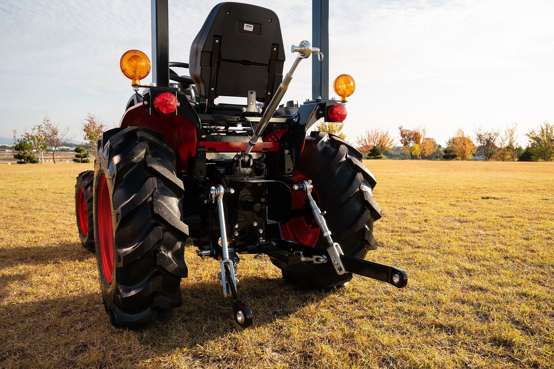 A TYM compact tractor with a front-end loader working on open ground