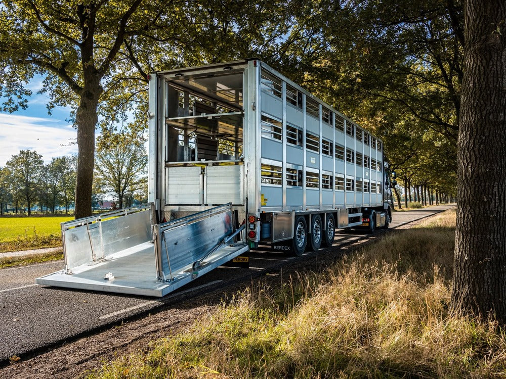 Berdex livestock trailer hitched behind a pickup truck